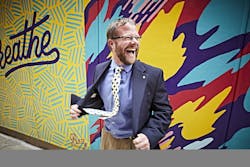 Under 40 philanthropist in front of mural