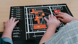 Two People Use Their Hands To Navigate A Campus Using A Tactile Map Two People Use Their Hands To Navigate A Campus Using A Tactile Map