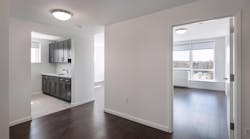Thwaites Place white interior with dark wood floors and cabinets