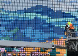 Construction workers building moving tech mural