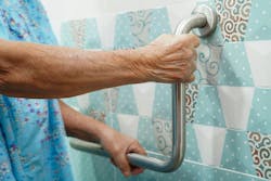 elderly old woman patient use toilet support rail in bathroom, handrail safety grab bar, security in nursing hospital
