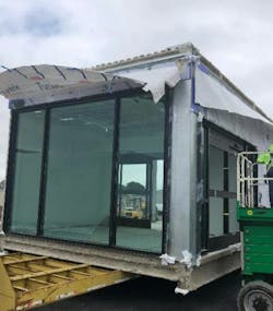 Module being prepared and loaded on truck bed for shipping to the site