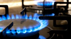 Gas stove. Closeup. Black gas stove and two burning flames close-up