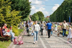 A lot of people walking in a city park on a day off A lot of people walking in a city park on a day off