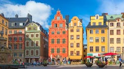 Stockholm, Sweden - July, 2018: Colorful facade of the houses in Stortorget Square Gamla Stan. Stockholm, Sweden with tourists at summer sunny day