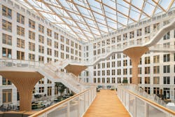 The interior view of the new office complex shows the impressive atrium of the wood-concrete hybrid structure. Photo courtesy Buro Happold The interior view of the new office complex shows the impressive atrium of the wood-concrete hybrid structure. Photo courtesy Buro Happold